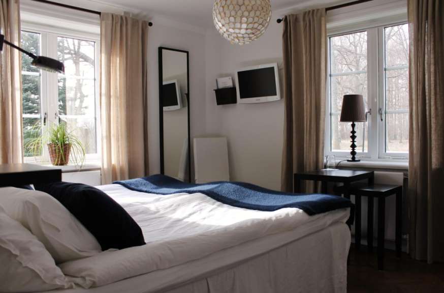 Ein Schlafzimmer mit einem Bett und zwei Fernsehern