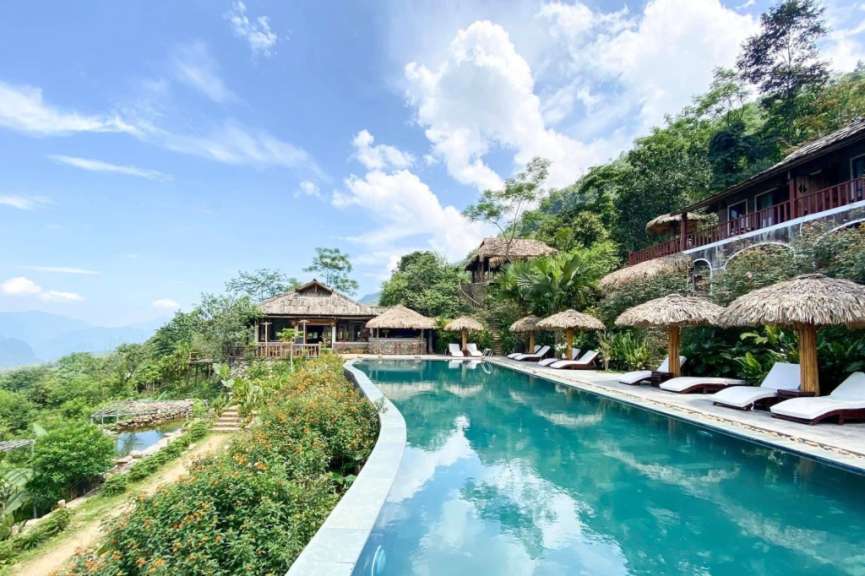 Ein großer Swimmingpool umgeben von Stühlen und Schirmen