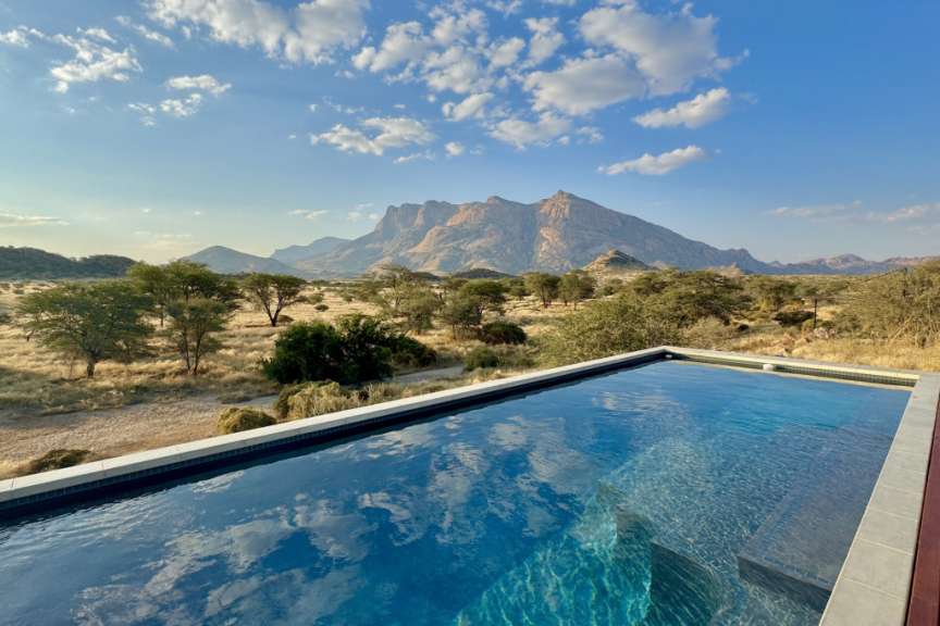 Ein Pool mit einem Berg im Hintergrund