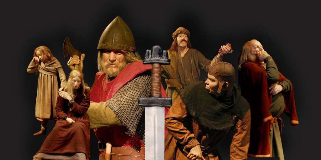 In diesem Bild sind mehrere Personen in historischen Kostümen zu sehen, die eine Szene darstellen, die einen großen Teil des Rahmens einnimmt.