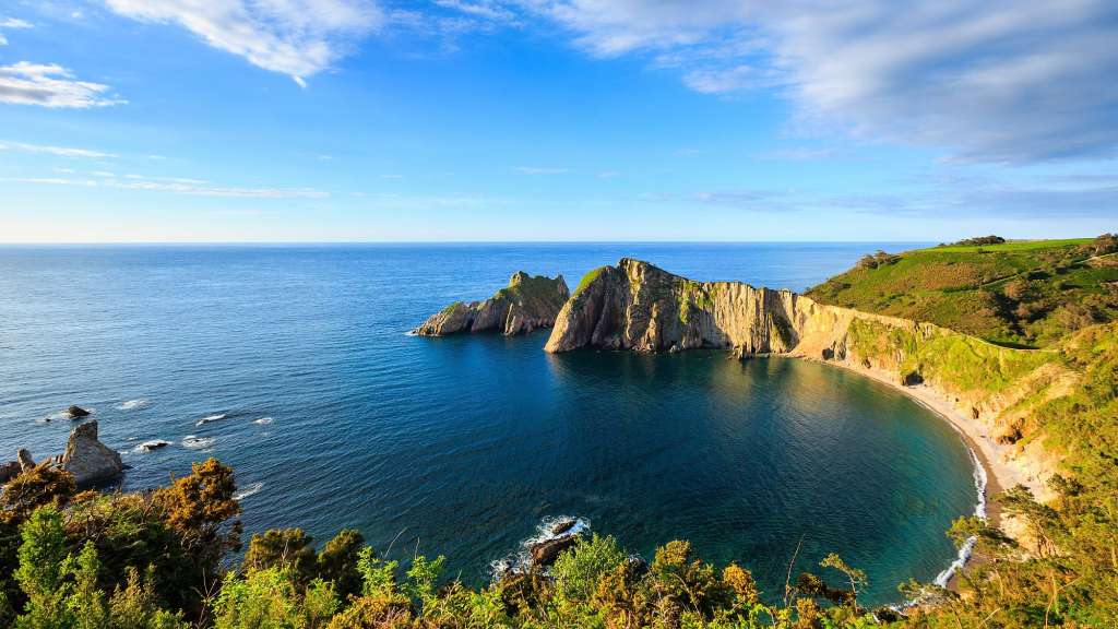 Ein großer blauer Ozean mit Felsen im Hintergrund