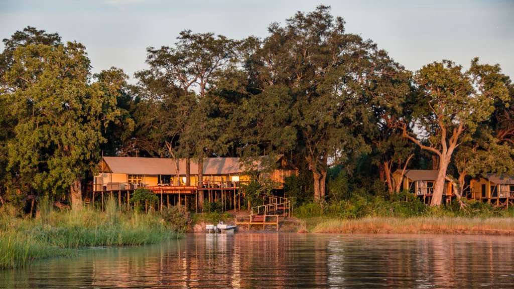 Ein Haus auf Stelzen steht am Ufer eines Flusses