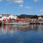 Ein kleiner Hafen mit roten Hütten und weißen Häusern