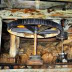 Ein großes Zahnrad sitzt auf einem Holzgestell