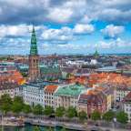 Eine Stadt mit vielen Gebäuden und einem grünen Turm