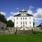 Ein großes weißes Gebäude mit einem Uhrturm darauf