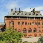 Ein großes rotes Gebäude mit einem Turm dahinter