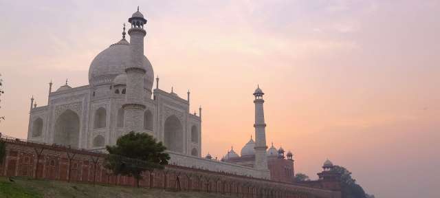 Taj Mahal: Morgenstimmung Eine große weiße Moschee steht neben einem Fluss