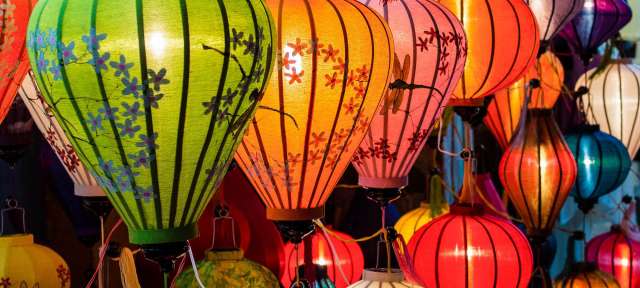 Hoi An: Lampions in allen Farben Eine Gruppe von bunten Laternen hängt an einer Wand