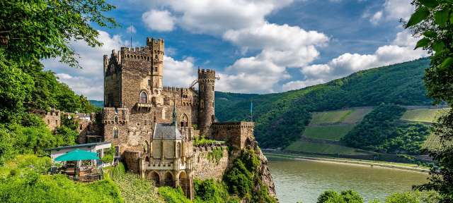 Schloss Rheinstein im Rheintal Ein altes Schloss auf einem Hügel mit Blick auf einen Fluss