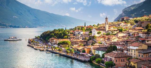 Limone Garda Eine Stadt am Ufer eines Sees mit einem Boot im Hintergrund