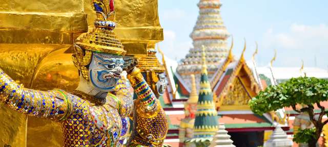 Bangkok: reich an Kultur und Geschichte Eine Statue steht vor einem goldenen Gebäude