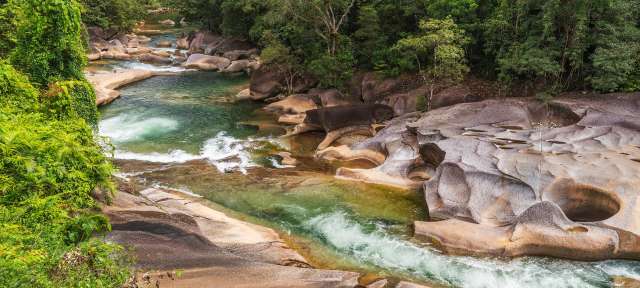 Ein Fluss fließt durch eine von Granitfelsen geprägte Landschaft im Dschungel.