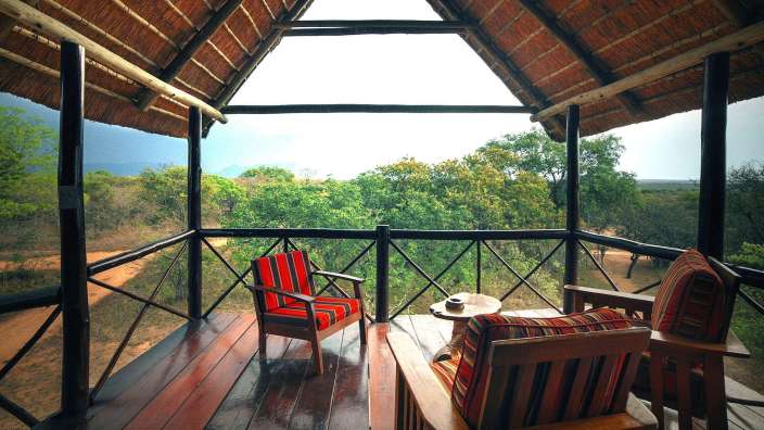 Ein Holzdeck mit Stühlen und einem Tisch darauf