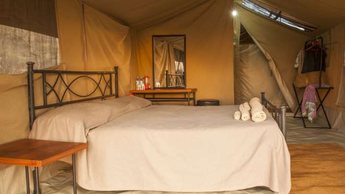 Ein Zelt mit einem Bett und einem Spiegel