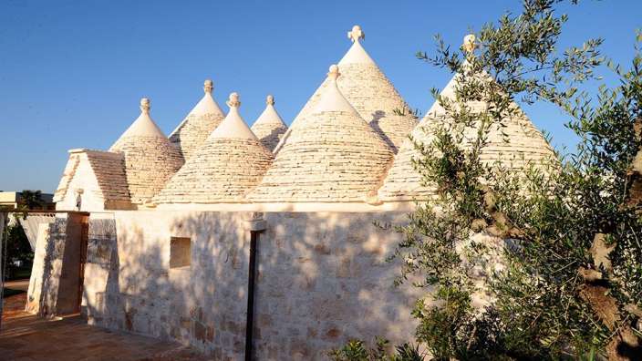 Ein weißes Gebäude mit drei kuppelförmigen Dächern