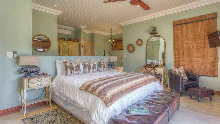 Ein Schlafzimmer mit einem Bett und einem Deckenventilator