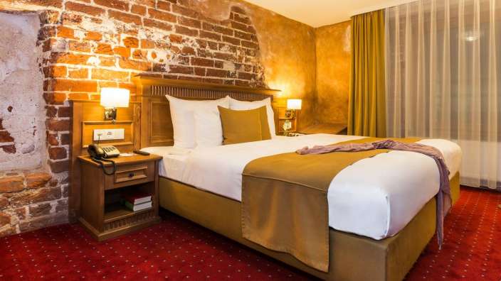 Ein Hotelzimmer mit einem Bett und einem Telefon