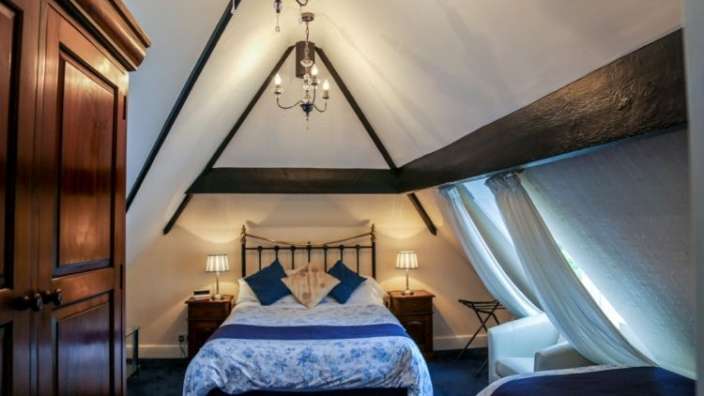 Ein Schlafzimmer mit zwei Betten und einem Kronleuchter