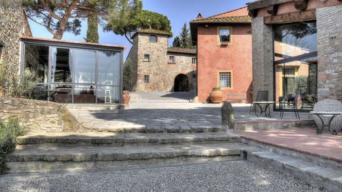 Ein kleines Gebäude mit einem Tisch und Stühlen davor