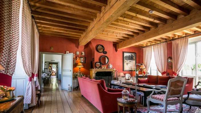 Ein Wohnzimmer mit roten Wänden und Holzböden