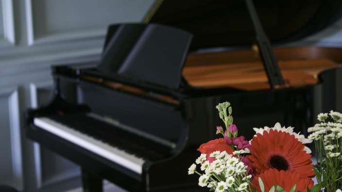 Ein Klavier mit einem Blumenstrauß davor