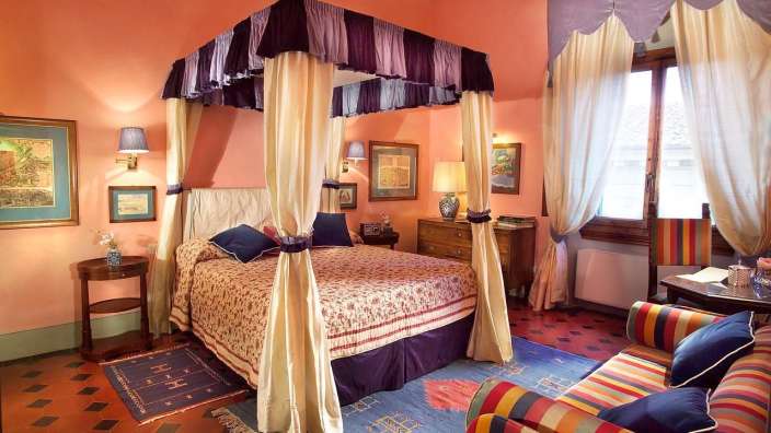 Ein Schlafzimmer mit einem Himmelbett und einer Couch