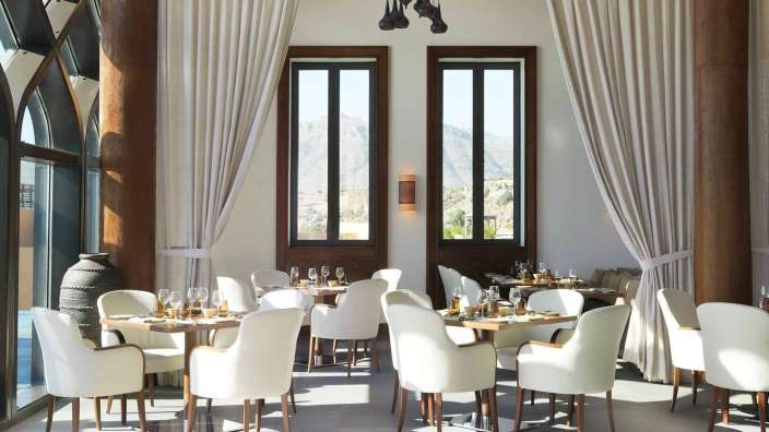 Ein Esszimmer mit weißen Stühlen und Tischen