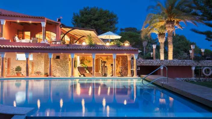 Ein großes Haus mit einem großen Pool davor