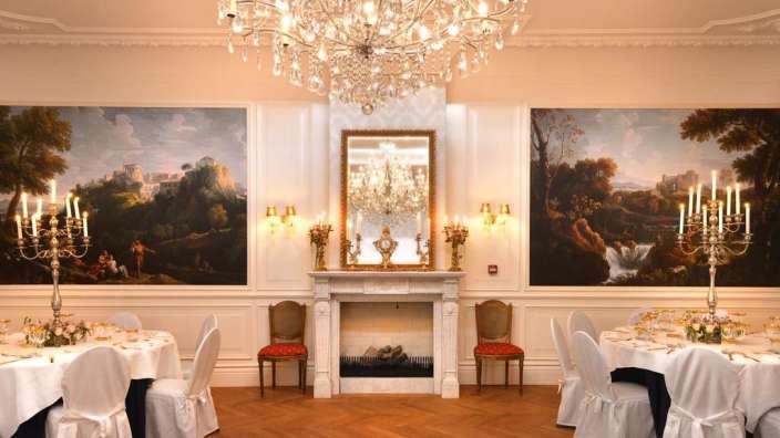 Ein Esszimmer mit einem Kamin und einem Kronleuchter