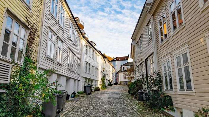 Eine schmale Gasse zwischen zwei Häusern mit vielen Fenstern