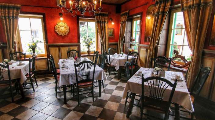 Ein Restaurant mit Tischen und Stühlen und einem karierten Boden