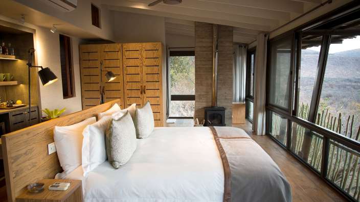 Ein Schlafzimmer mit einem großen Bett und vielen Fenstern