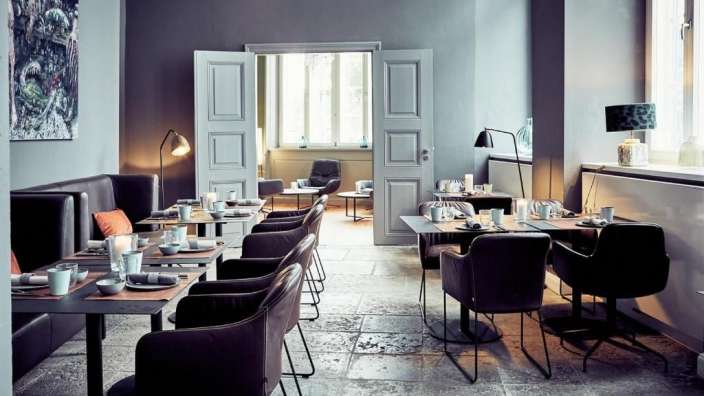 Ein Esszimmer mit vielen Tischen und Stühlen