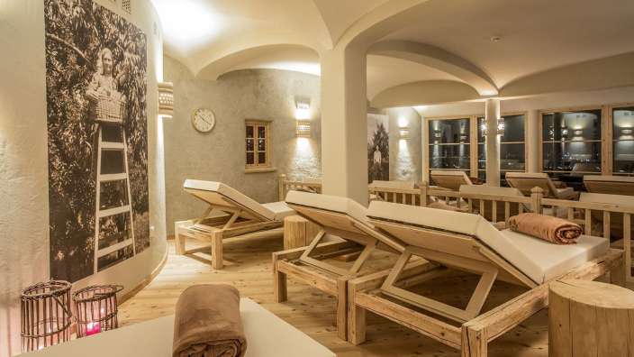 Ein Zimmer mit Holzliegestühlen und einer Uhr an der Wand