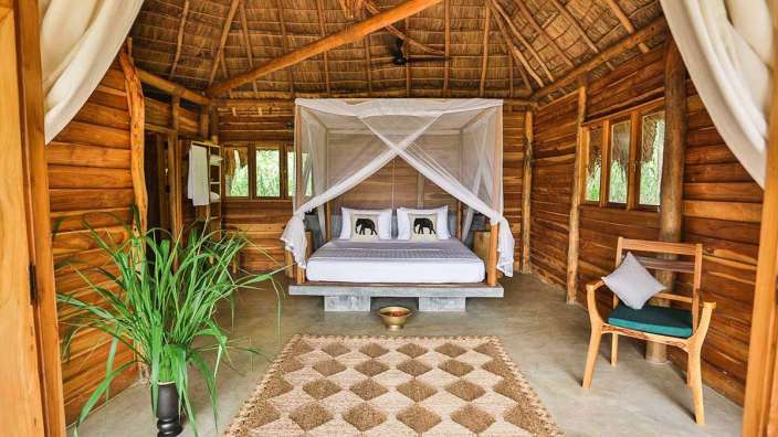 Ein Holzhaus mit einem Bett und einem Teppich