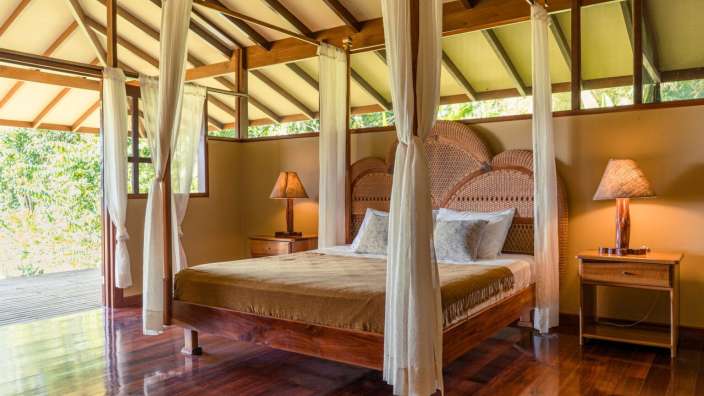 Ein Schlafzimmer mit einem Himmelbett und einer Lampe