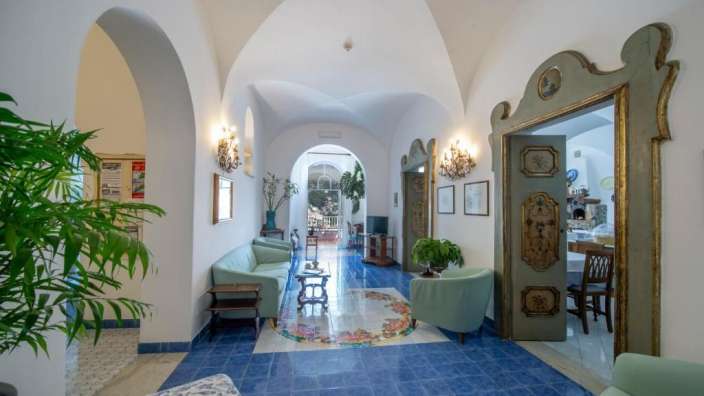 Ein Flur mit blauen Fliesen und weißen Wänden