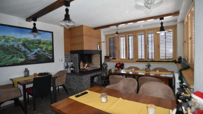 Ein Esszimmer mit Tischen und Stühlen und einem Kamin