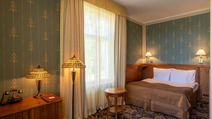 Ein Hotelzimmer mit einem Bett und einer Lampe