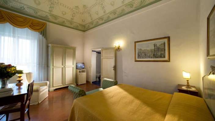 Ein Schlafzimmer mit einem Bett und einem Bild an der Decke