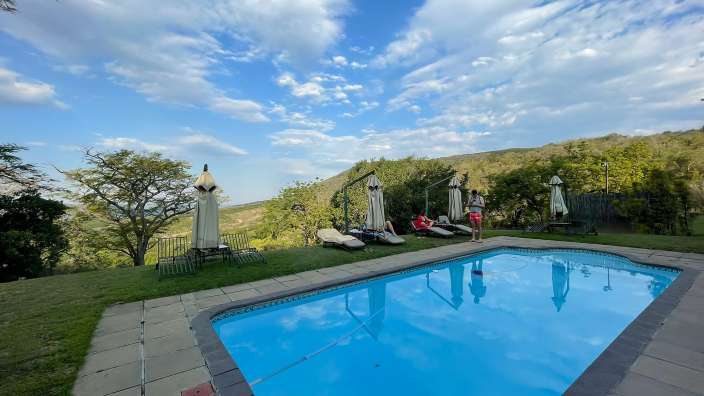 Eine Gruppe von Menschen steht neben einem Swimmingpool