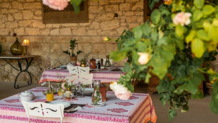 Ein Tisch mit einem rosa und orangefarbenen Tischtuch