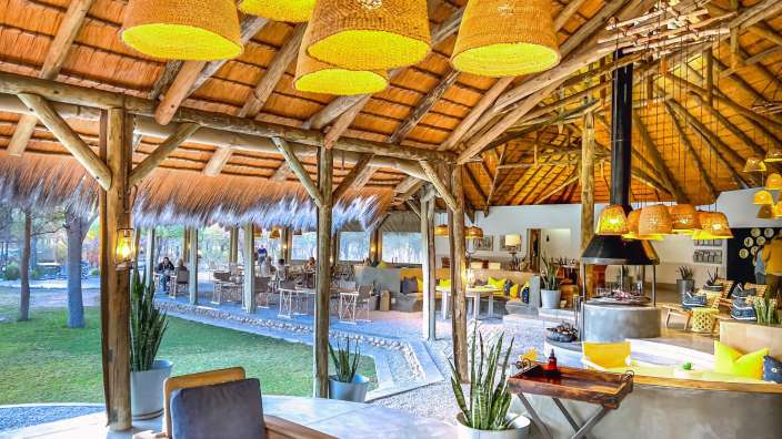 Ein großer Raum mit einem Strohdach und vielen Lampen