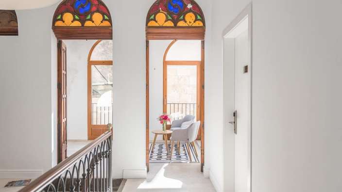 Ein Flur mit einem Stuhl und einem Tisch in der Mitte