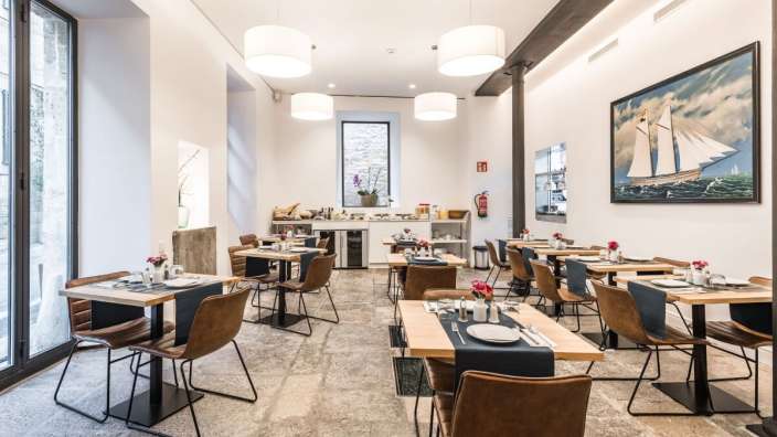 Ein Esszimmer mit einem Gemälde eines Segelschiffes an der Wand