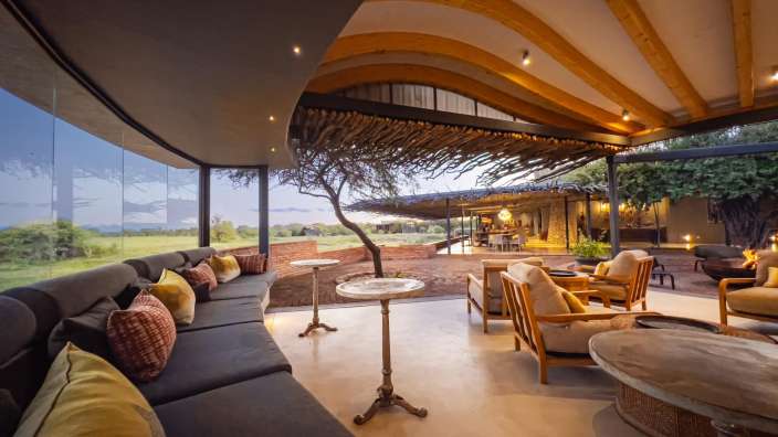 Ein Wohnzimmer mit vielen Möbeln und einem Baum im Hintergrund