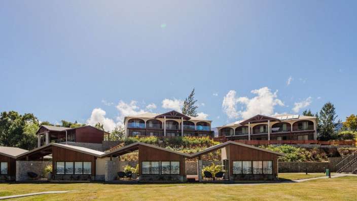 Eine Reihe von Häusern auf einem Hügel mit einem blauen Himmel dahinter