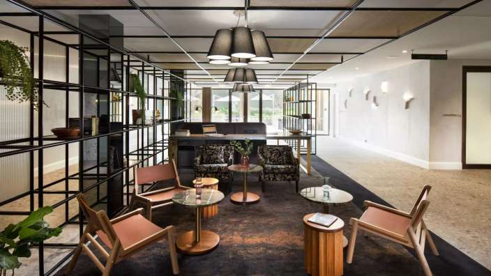 Ein Wohnzimmer mit vielen Stühlen und Tischen