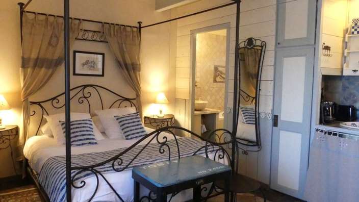 Ein Schlafzimmer mit einem Himmelbett und einem blauen Tisch